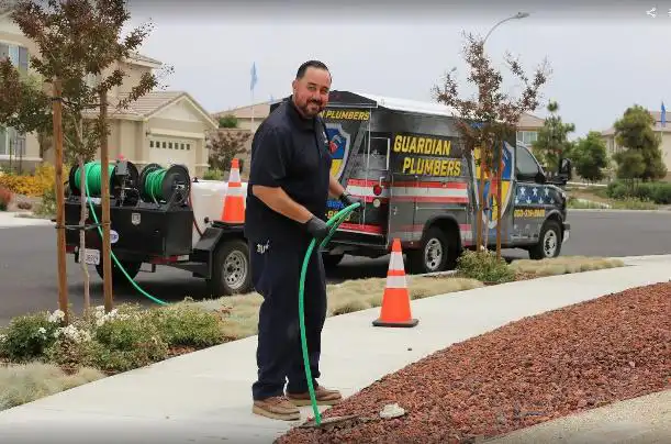 worker green hose smiling