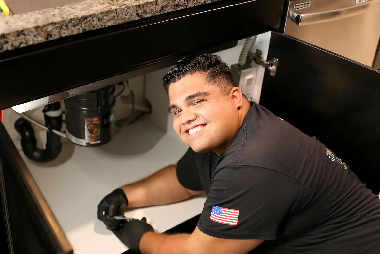 man smiling under sink